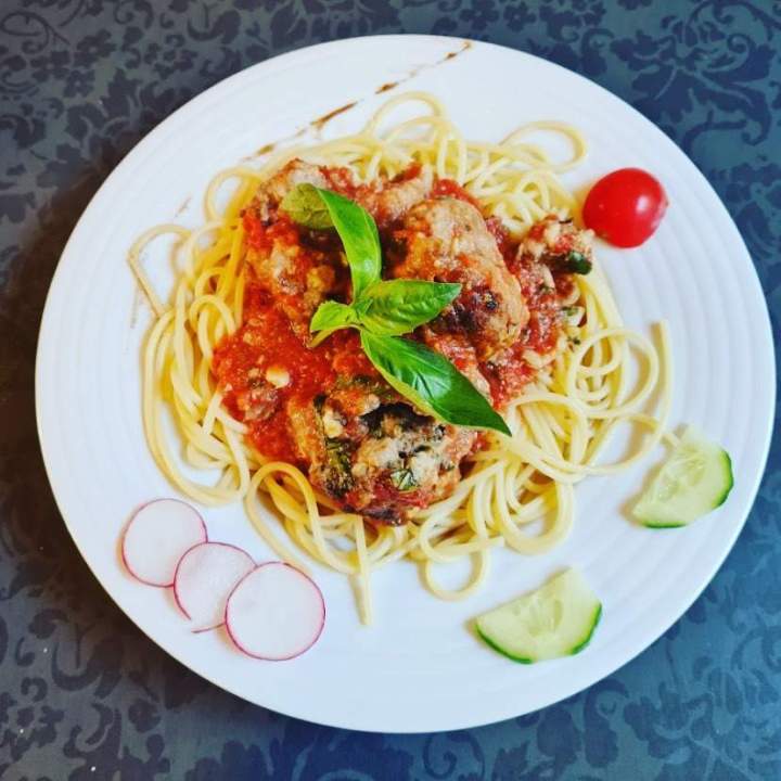 Spaghettis aux boulettes de viande, recouverts d'une sauce tomate Arras